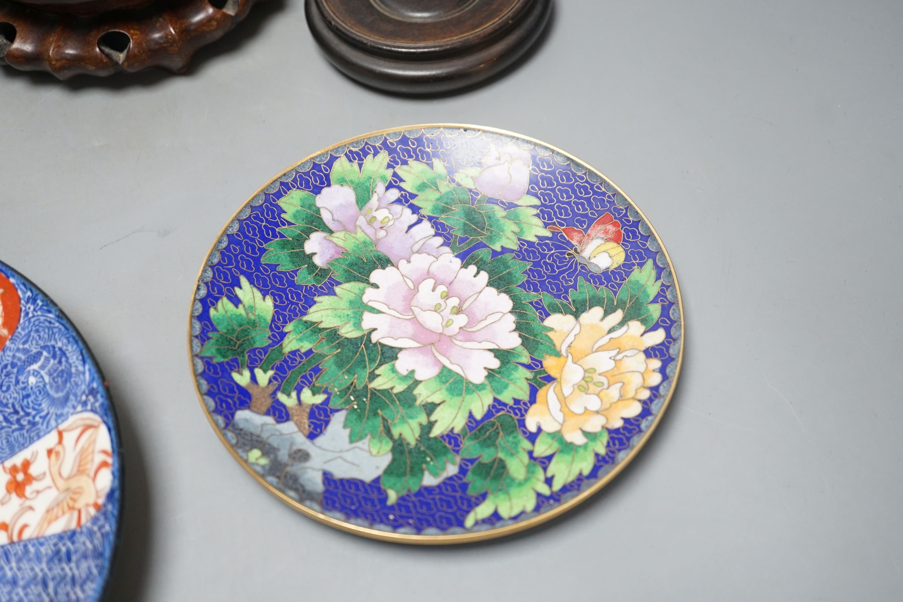 A Continental porcelain jam pot, 15cm tall, and cover with stand, together with 2 Chinese hardwood stands, enamelled plate and another (7)